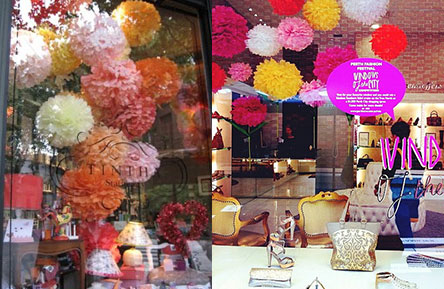 Tissue paper pom poms in window displays