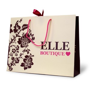 pink and brown on a cream paper bag with pink satin ribbon and rope handles