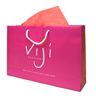 pink and white paper bag with white rope handles